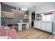 Stylish living space with modern shelving, desk, and a comfortable pink sofa at 11957 Vermillion Ave, Windermere, FL 34786