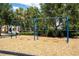 Community playground featuring swings surrounded by lush trees at 11957 Vermillion Ave, Windermere, FL 34786