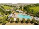 Aerial view of the community pool with ample seating, palm trees, and lounge chairs at 11957 Vermillion Ave, Windermere, FL 34786