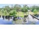 Breathtaking aerial view of a lakeside home with a private dock and lush landscaping at 12454 S Lake Mary Jane Rd, Orlando, FL 32832