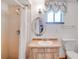 Bathroom showcasing a standing shower, a vanity with a sink, and a toilet at 12454 S Lake Mary Jane Rd, Orlando, FL 32832