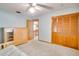 Cozy bedroom features natural wood details, an armoire, and an open doorway to a kitchen at 12454 S Lake Mary Jane Rd, Orlando, FL 32832