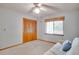 Cozy bedroom features a window, ceiling fan, and spacious closet at 12454 S Lake Mary Jane Rd, Orlando, FL 32832