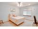 Well-lit bedroom offers neutral tones, carpet flooring, and a ceiling fan for a simple and comfortable ambiance at 12454 S Lake Mary Jane Rd, Orlando, FL 32832
