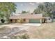 Beautiful single-story home with two-car garage, stone accents, and lovely front lawn with pergola at 12454 S Lake Mary Jane Rd, Orlando, FL 32832