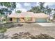 Charming single-story home with a two-car garage, stone accents, and well-manicured lawn at 12454 S Lake Mary Jane Rd, Orlando, FL 32832