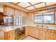 Classic kitchen featuring wood cabinetry, a cozy breakfast bar, and a serene water view at 12454 S Lake Mary Jane Rd, Orlando, FL 32832