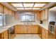 Well-lit kitchen with wood cabinets, stainless steel appliances, and view of the lake through the window at 12454 S Lake Mary Jane Rd, Orlando, FL 32832