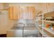 Functional laundry room includes cabinetry, shelving, and side-by-side washer and dryer units at 12454 S Lake Mary Jane Rd, Orlando, FL 32832