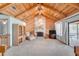 Inviting living room featuring vaulted ceilings, stone fireplace, and sliding doors to the outdoor area at 12454 S Lake Mary Jane Rd, Orlando, FL 32832