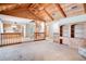 Open-concept living area with vaulted ceilings, access to spiral staircase, and views into the kitchen at 12454 S Lake Mary Jane Rd, Orlando, FL 32832