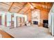 Cozy living room with vaulted ceilings, a stone fireplace, and comfortable seating area at 12454 S Lake Mary Jane Rd, Orlando, FL 32832
