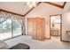 Spacious main bedroom with wood accents, vaulted ceiling and a sliding door leading to the deck at 12454 S Lake Mary Jane Rd, Orlando, FL 32832