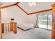 Spacious bedroom featuring vaulted ceilings and a sliding door providing access to the outdoors at 12454 S Lake Mary Jane Rd, Orlando, FL 32832