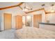 Bright main bedroom featuring vaulted ceilings and an attached bathroom at 12454 S Lake Mary Jane Rd, Orlando, FL 32832