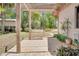 Cozy patio with a charming swing, perfect for relaxation and enjoying the peaceful surroundings at 12454 S Lake Mary Jane Rd, Orlando, FL 32832
