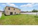 Expansive backyard featuring a well-maintained lawn and partial fencing, perfect for outdoor activities at 13054 Prairie Meadows Dr, Orlando, FL 32837