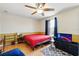 Bright bedroom featuring a ceiling fan, natural light, and space for entertainment with modern television set at 13054 Prairie Meadows Dr, Orlando, FL 32837