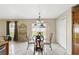 Dining area features a glass table, stylish chairs, and a view of the backyard at 13054 Prairie Meadows Dr, Orlando, FL 32837