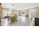 Open dining space featuring tile flooring, neutral paint, and a contemporary chandelier at 13054 Prairie Meadows Dr, Orlando, FL 32837