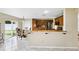 Kitchen area boasts wooden cabinetry, stainless steel appliances, and a breakfast bar at 13054 Prairie Meadows Dr, Orlando, FL 32837