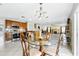 Open concept kitchen and dining area with stainless appliances and wooden cabinets at 13054 Prairie Meadows Dr, Orlando, FL 32837