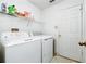 Clean laundry room equipped with modern washer and dryer units, and storage shelves at 13054 Prairie Meadows Dr, Orlando, FL 32837