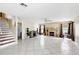 Open-concept living room featuring tile flooring, a fireplace, and staircase at 13054 Prairie Meadows Dr, Orlando, FL 32837