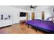 Bright main bedroom features wood floors, ceiling fan, and ensuite bathroom at 13054 Prairie Meadows Dr, Orlando, FL 32837