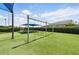 Common picnic area with tables and a sunshade, set on artificial turf, perfect for outdoor gatherings at 13054 Prairie Meadows Dr, Orlando, FL 32837
