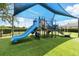 Community playground featuring modern play structures, a slide, and soft, artificial turf for safety at 13054 Prairie Meadows Dr, Orlando, FL 32837