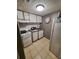 Efficient kitchen with standard appliances, featuring neutral countertops, tile floors, and bright overhead lighting at 131 Water Front Way # 200, Altamonte Springs, FL 32701