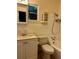 Cozy bathroom with white tiled shower/tub combination, toilet, white vanity, and a window with view at 1399 Aloma Ave, Winter Park, FL 32789
