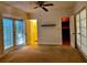 Spacious bedroom features carpet floors, closet, ceiling fan, and access to the back yard through glass doors at 1399 Aloma Ave, Winter Park, FL 32789