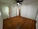 Bedroom with hardwood floors, ceiling fan, and closet space visible through open doors at 1399 Aloma Ave, Winter Park, FL 32789