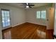 Bright bedroom with wood floors, a ceiling fan, and a glass-paneled door leading to an outdoor space at 1399 Aloma Ave, Winter Park, FL 32789