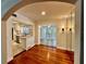 Well-lit dining area with hardwood floors, opening up to the kitchen and bright sunroom at 1399 Aloma Ave, Winter Park, FL 32789
