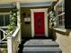 Inviting front entrance featuring a bright red door, decorative plants, and a well-lit porch at 1399 Aloma Ave, Winter Park, FL 32789