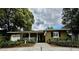 Charming single-story home with a brick walkway, covered porch, and well-maintained landscaping at 1399 Aloma Ave, Winter Park, FL 32789