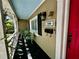 Cozy front porch with seating, stylish lighting, and unique address plaque detail at 1399 Aloma Ave, Winter Park, FL 32789