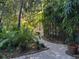 Picturesque garden path surrounded by lush greenery, creating a serene and inviting outdoor space at 1399 Aloma Ave, Winter Park, FL 32789