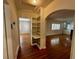 Entryway with hardwood floors, built-in shelves, and arched doorways leading to other rooms at 1399 Aloma Ave, Winter Park, FL 32789