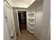 Hallway featuring storage cabinets and shelving, with access to additional storage space or utilities at 1399 Aloma Ave, Winter Park, FL 32789