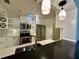 Modern kitchen with stainless steel appliances, bright lighting, and a breakfast bar with sink at 1399 Aloma Ave, Winter Park, FL 32789