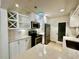 A well-lit kitchen with stainless steel appliances, white cabinets, and a convenient wine rack at 1399 Aloma Ave, Winter Park, FL 32789