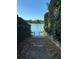Picturesque lake view with lush greenery and a quaint dock for serene waterfront living at 1399 Aloma Ave, Winter Park, FL 32789
