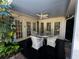 Covered patio featuring a fan, black flooring, and a table with four chairs for outdoor dining at 1399 Aloma Ave, Winter Park, FL 32789