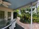 Covered outdoor patio and a brick path leading to a lush green yard at 1399 Aloma Ave, Winter Park, FL 32789