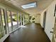 Enclosed sun room with multiple access points to the exterior and a skylight overhead at 1399 Aloma Ave, Winter Park, FL 32789