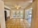 Bright sun room featuring tile floors, ceiling fan, and multiple access points to the exterior at 1399 Aloma Ave, Winter Park, FL 32789